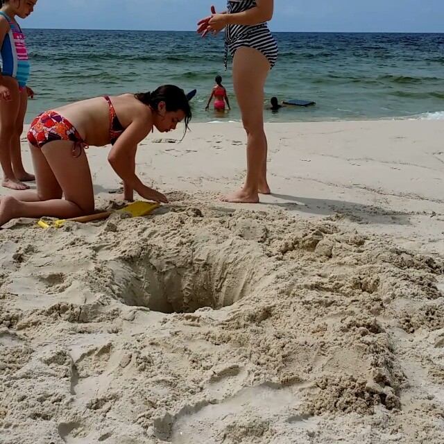Sand cap pops up out of Leah's digging hole. #SaltWaterLife #SaltLife #OrangeBeachCondo #OrangeBeach