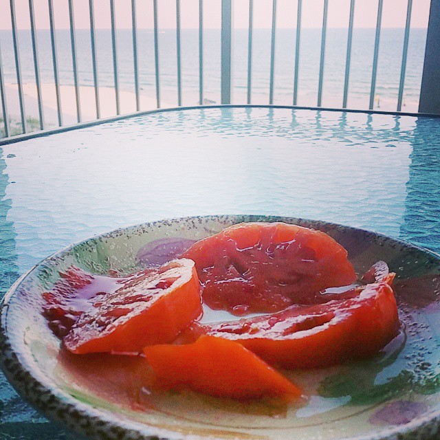 Heirloom tomatoes at the beach. Too good to cook with, way too refined for a hamburger.  Slice, salt, serve.  Good like a steak.  Beach life at its best! #HeirloomTomatoes #BeachLife #GulfShores #OrangeBeachCondo